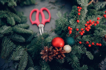 Christmas tree wreath decorating workshop DIY set scissors for making on table.の写真素材