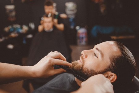 Man hipster having barber shave barbershop scissors.の写真素材