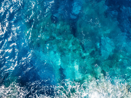 Raging blue water of open Mediterranean Sea with turquoise bottom. top viewの写真素材