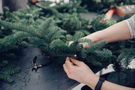 Christmas tree wreath decoration with woman hand workshop DIYの写真素材