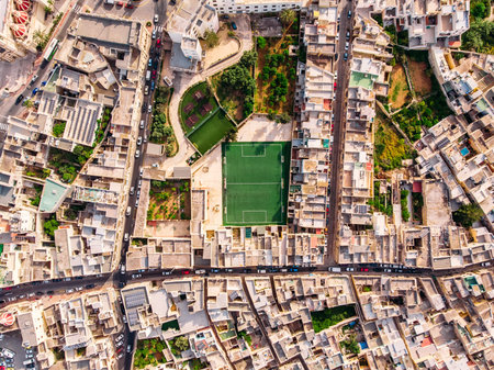 Football field surrounded by stone city. Turkey Malta. Aerial top viewの写真素材