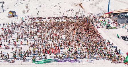Sheregesh, Kemerovo region, Russia - April 13, 2019: Grelka Fest ski and snowboard riders in bikini. Aerial photoのeditorial素材