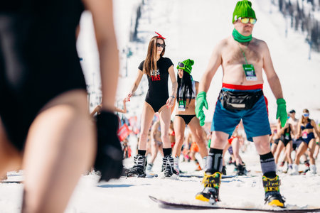 Sheregesh, Kemerovo region, Russia - April 13, 2019: Grelka Fest ski and snowboard riders in bikini