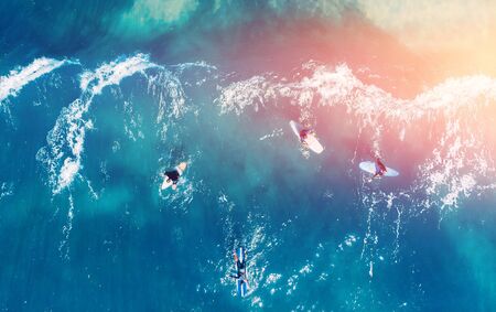 Group of novice surfers are learning to embark on wave. Aerial top viewの写真素材