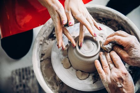 Learning pottery, old hands of teacher. Concept mentorの写真素材