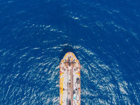 Oil ship chemical tanker sails blue sea. Aerial top view. Concept exportの写真素材