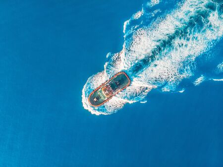 Tugboat blue sea port. Aerial top viewの写真素材