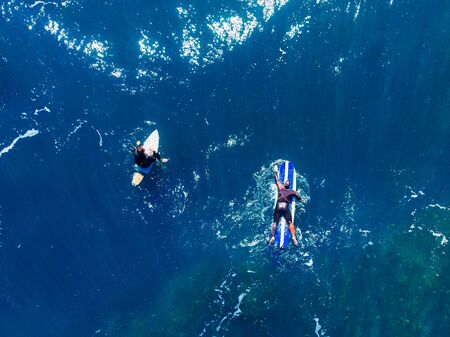 Group of novice surfers are learning to embark on wave. Aerial top viewの写真素材