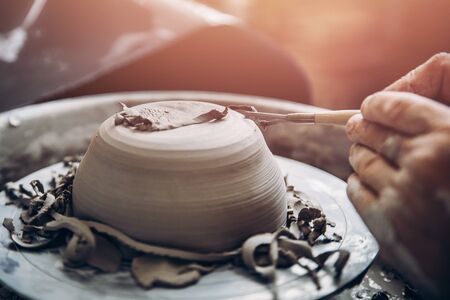 Turkish master paints and cuts clay plate patterns. Concept craftの写真素材