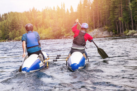 Extreme couple on kayak rafting mountain river.