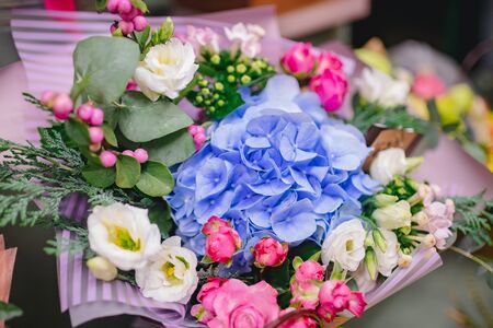 Colorful bright bouquets red, pink, blue, green, yellow colour from flowers of roses, chrysanthemums, eucalyptus, orchidsの写真素材