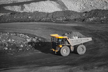Big yellow mining truck body loaded anthracite. Open pit mine, extractive industry for coal.の写真素材