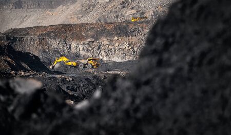 Banner Open pit mine industry, excavator loading coal on big yellow mining truck for anthraciteの写真素材