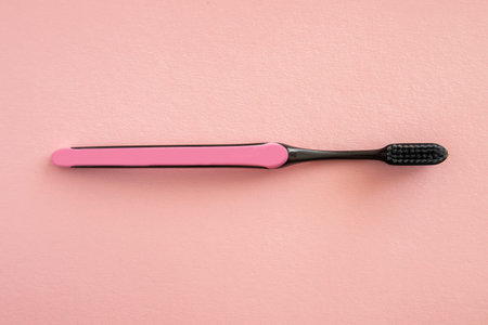 Toothbrush for brushing teeth on pink background, pastel colors.の写真素材
