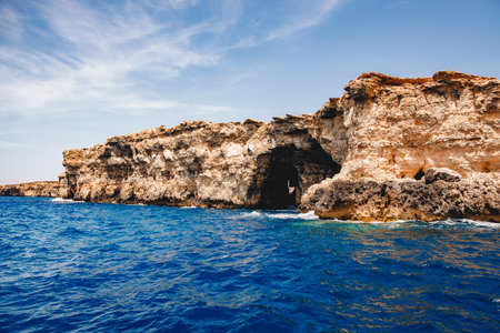 Panorama beach Blue Lagoon Comino Malta. Rocky coast with window and arch Mediterranean Sea.