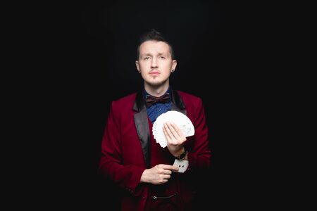 Illusionist pulls out ace from his sleeve. Concept advantage in situationの写真素材