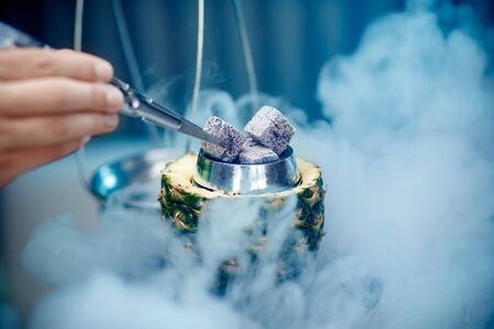 Hot coals hookah in pineapple bowl for smoking shisha traditional Turkish holidayの写真素材