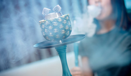 Hot coals hookah in pineapple bowl for smoking shisha traditional Turkish holiday.