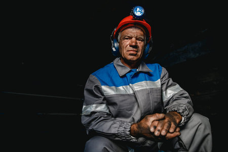 Portrait miner coal man in helmet with lantern in underground mine. Concept industrial engineerの写真素材
