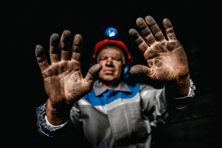 Miner dirty hands after working on coal mine. Concept industrial engineerの写真素材