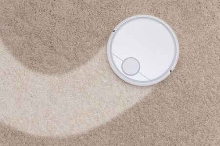Robotic wireless smart vacuum cleaner working on white with pile carpetの写真素材