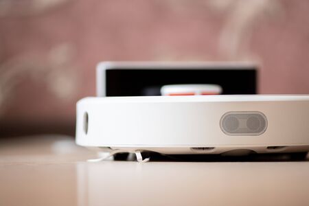 Robotic wireless smart vacuum cleaner stands base of charging.の写真素材