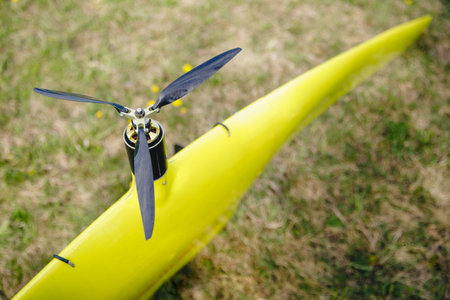Close up electric motor with propeller aircraft model for cartography and military.