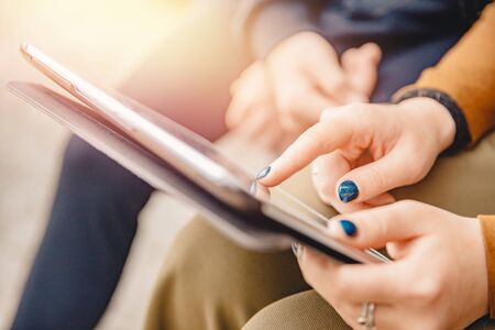 Teaching teenagers using computer tablet, girl finger points screen. Technology concept schoolの写真素材