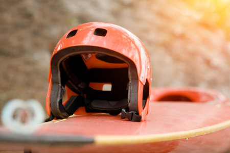 Helmet and paddle for kayaking. Extreme sport concept on mountain river.