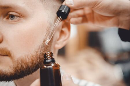 Oil for care and growth of beard, barbershop.の写真素材