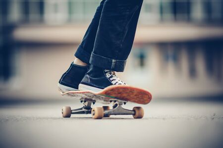 Skateboard man practices to ride on asphalt, learns tricks.の写真素材