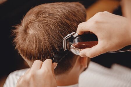 Barber master hairdresser does hairstyle scissors and comb. Concept Barbershopの写真素材
