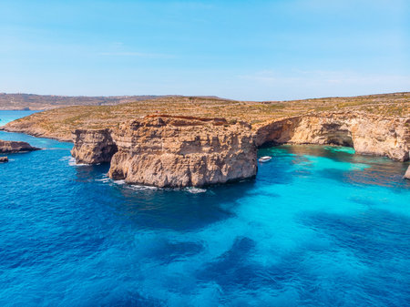 Concept paradise vacation. White yacht with sail in clear water of sea with sand. Blue Lagoon Comino...