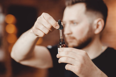 Oil for beard in dropper, process of moisturizing hair