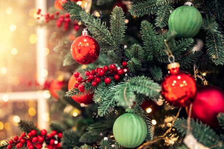 Christmas background pine tree branch with decorations red balls gifts and star, with bokeh light.の写真素材