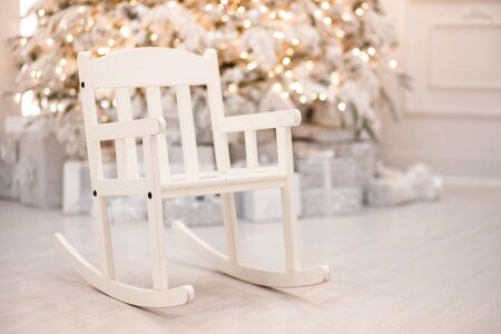 Interior Christmas room silver retro sleigh chair white in light illuminations.の写真素材