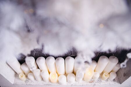 Christmas decor candle light, fireplace background bokeh illumination night mood, golden colorの写真素材