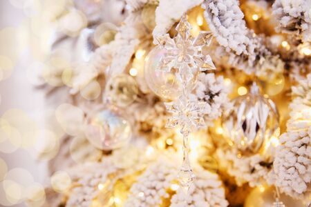 Christmas white tree decorated snow illumination and gifts toys, background light bokehの写真素材