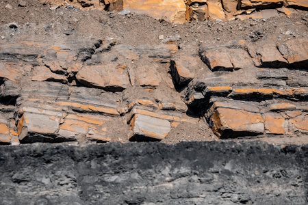Geological section of soil, layers of coal and rock. Overburden open mine anthracite. Dark texture...