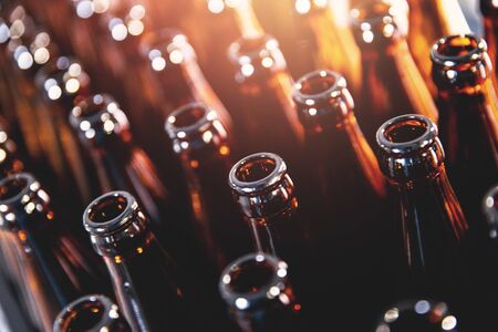Closeup open brown glass dark bottles for beer alcohol, lens flareの写真素材