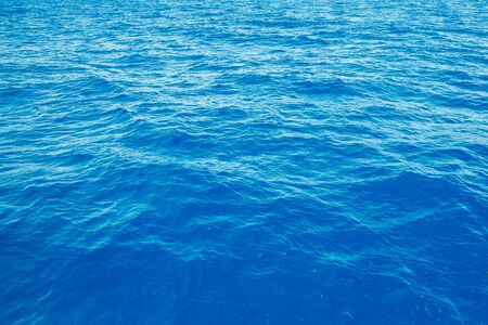 Natural background blue sea with waves, azure clear water beach. Aerial top view.の写真素材