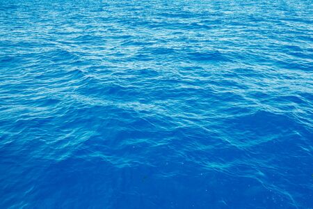 Natural background blue sea with waves, azure clear water beach. Aerial top view.