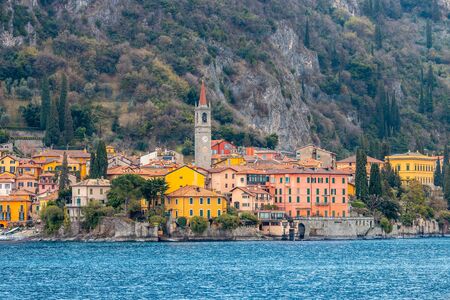 Evening view city Bellagio and Varenna Como water lake Italy blue sky mountain.の写真素材