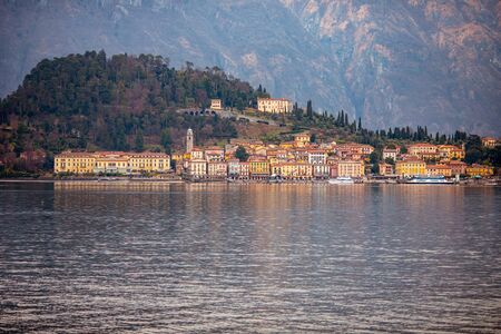 Evening view city Bellagio and Varenna Como water lake Italy blue sky mountain.の写真素材