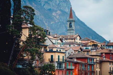 Evening view city Bellagio and Varenna Como water lake Italy blue sky mountain.の写真素材