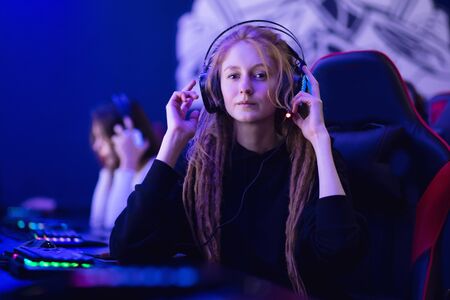 Streamer beautiful girl professional gamer winnerplaying online games computer with headphonesの写真素材