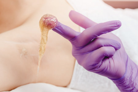 Woman underarm shugaring paste hair removal procedure beauty salon. Epilation concept