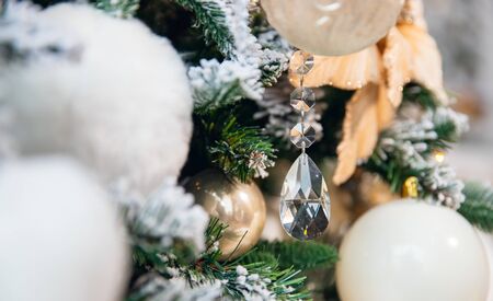 Christmas background golden flowers cones tree with branches of spruce, covered with white artificial snow and balls felt.の写真素材