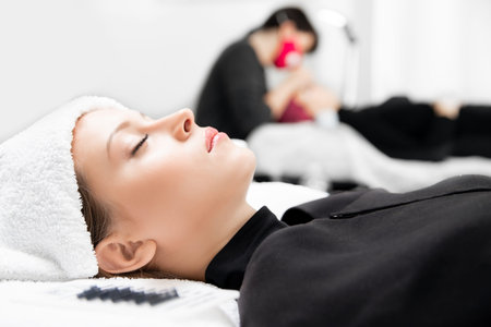 Eyelashes extensions. Lash extension procedure in spa beauty salon