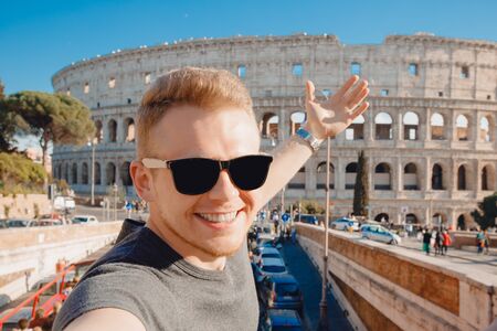 Happy young man making selfie in sunglasses Colosseum in Rome, Italy. Concept travel tripの写真素材